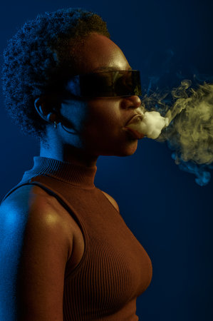 Passion woman blowing smoke curls