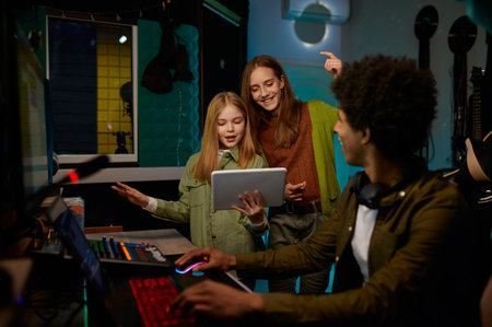 Two young artists rehearsing, music producer listening song