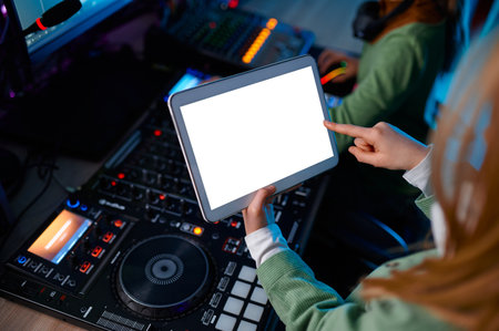 Closeup digital tablet over sound mixerの写真素材
