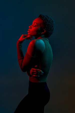 Stylish young woman in blue red neon lightの写真素材