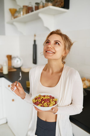 Happy slim woman enjoying dietary delicious food for breakfast