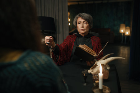 Gypsy reading spell for client using witchcraft book and magic pendulumの写真素材