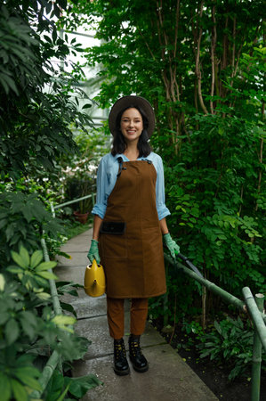 Young woman gardener working in botanic gardenの写真素材