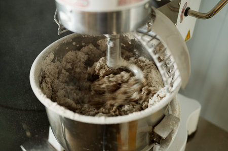Closeup for bread making process by using flour mixing machine in factoryの写真素材