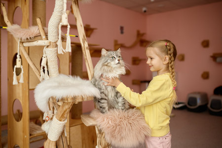 Little girl playing with new adopted cat from domestic animal shelterの写真素材
