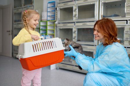 Happy mother and child taking kitten to home putting in carrierの写真素材