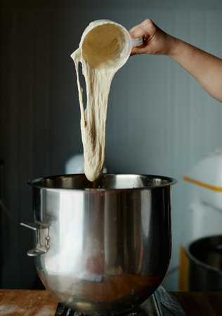Closeup of bread dough weighing in professional scale at bakery shopの写真素材