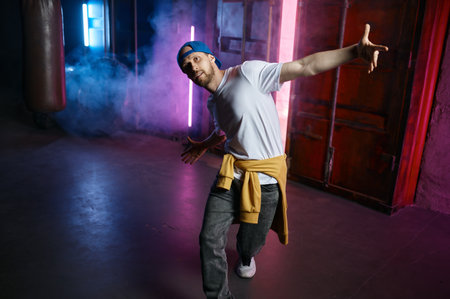 Cool and happy Hip hop dancer in trendy street clothes dancing