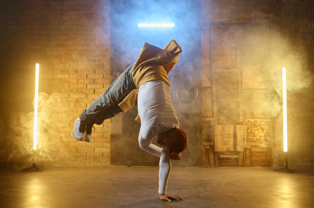 Male street artist b-boying performing breakdancing active trainingの写真素材