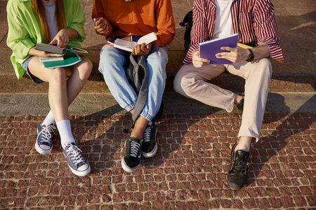 Closeup cropped shot of students group doing homework outdoorsの写真素材