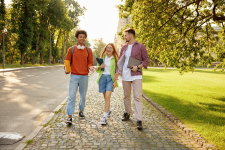 Casual diverse students chatting while walking and hanging out togetherの写真素材