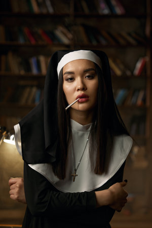 Portrait of naughty sexy nun smoking cigaretteの写真素材