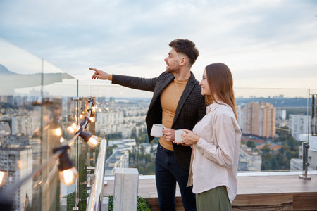 Business colleagues chitchatting during coffee break at office roof terraceの写真素材