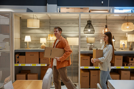 Young family couple shopping at modern lamp store market