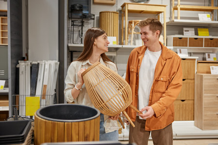 Cheerful man and woman couple deciding to buy craft furniture for home