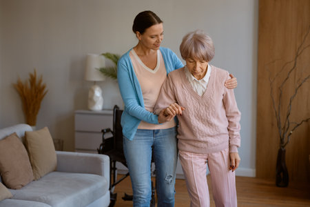 Young daughter caring for retired mom with physical or mental disorderの写真素材
