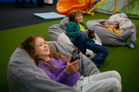 Little children playing video game in entertainment center