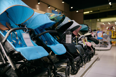 Variety of baby carriages and strollers in row at in newborn kids section