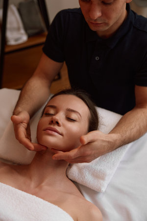 Closeup of professional masseuse doing stress relief massageの写真素材