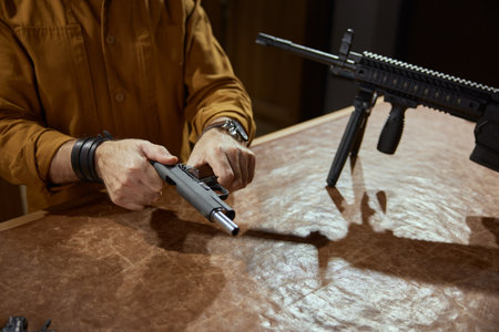 Male retailer or client reloading handgun portrait with selective focusの写真素材