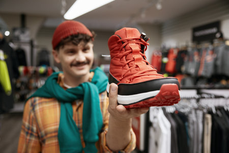 Man choosing sports sneakers shoes at sports shop storeの写真素材