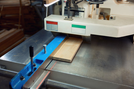 Thickness planer machine to trim wood plank closeup view, woodworking workshop