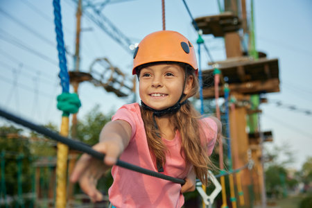 Young girl accuracy walking rope track enjoying extreme entertainmentの写真素材