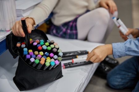 Closeup view on children hands choosing colorful crayons for drawingの写真素材