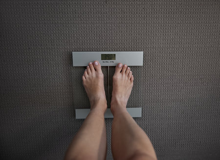 View of female feet on scale showcasing body weightの写真素材