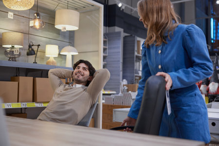 Couple relax in stylish office furniture showroom showcasing modern designsの写真素材