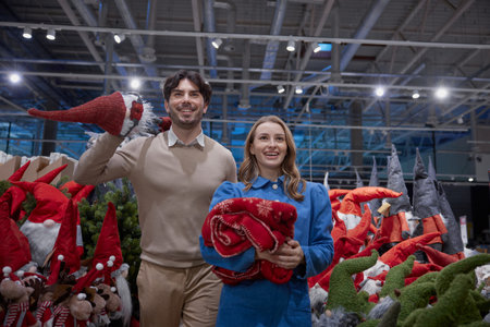 Couple joyfully picks out holiday decorations in delightful store full of festive gnomes