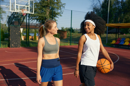 Beautiful young sports women basketball player on outdoor courtの写真素材