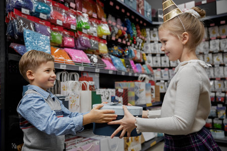 Little boy and girl children shopping for birthday party in shopの写真素材