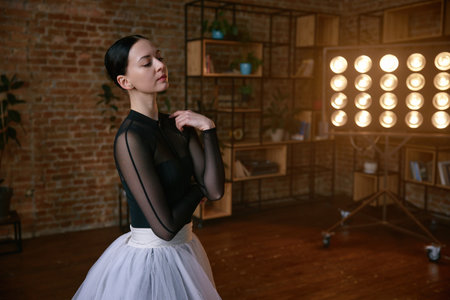 Elegant female dancer in an artistic pose set against a striking urban backgroundの写真素材
