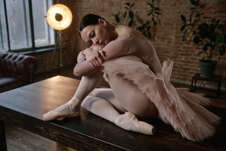 An elegant ballerina is posing gracefully on a table in a beautiful artistic settingの写真素材
