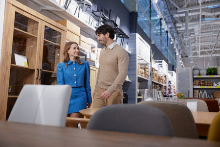 A lovely couple happily exploring a modern furniture store display together, enjoying their timeの写真素材