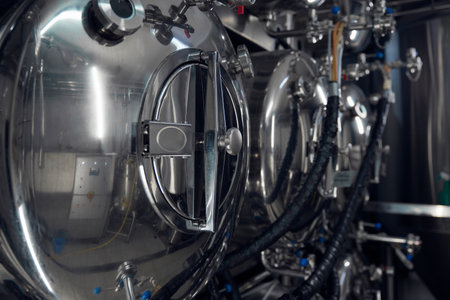 A large open stainless steel tank reveals its interior for observation