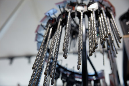 A whole bunch of various drill bits are hanging from a rackの写真素材