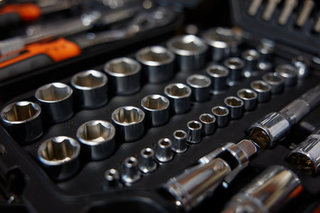 A collection of various sockets and wrenches gathered in a box