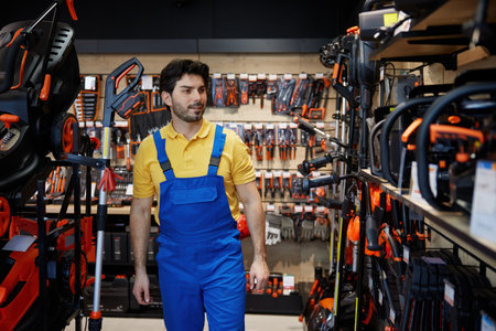 A man choosing a lawn mower inside a retail storeの写真素材