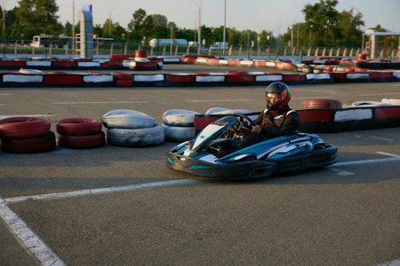 A thrilling go-kart professional racer speeds on an outdoor training trackの写真素材