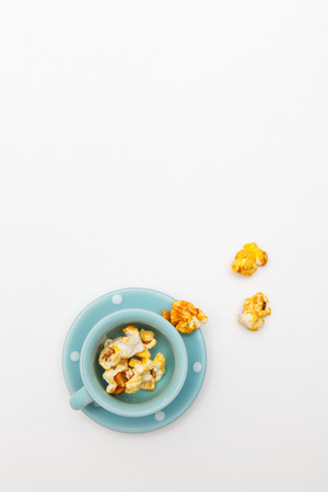 popcorn in dish on white backgroundsの写真素材
