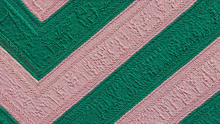 Green and pink striped fabric texture background. Close-up image.の素材