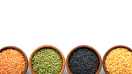 Different types of lentils in wooden bowls isolated on white background.の素材