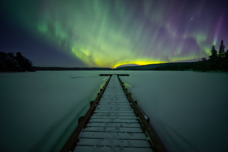 Aurora borealis, northern lights over frozen lake in winterの素材