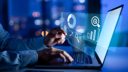 Marketing strategy concept. Businessman working on laptop at night.の素材