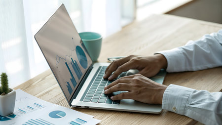 Businessman analyzing investment charts with laptop. Business and financial concept.の素材