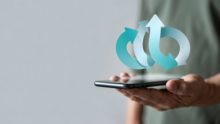 Businessman using smart phone with blue arrows on grey background, business conceptの素材