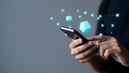 Businessman hand using mobile smart phone with 3d polygonal network connection on gray backgroundの素材