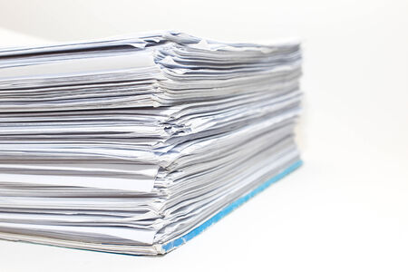 A busy sheets of paper stack on desk isolated 